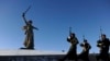 Honor guards march past the giant monument built to honor those who died in the World War II Battle of Stalingrad.