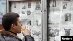 Moldova -- A man reads morning newspapers in Chisinau, 29Nov2010