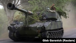 Ukrainian soldiers drive a U.S.-made 155-mm turreted M109 self-propelled howitzer in the Donetsk region on June 13.