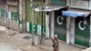 A soldier patrols a Mingora street, in Swat Valley, during curfew hours on April 20.