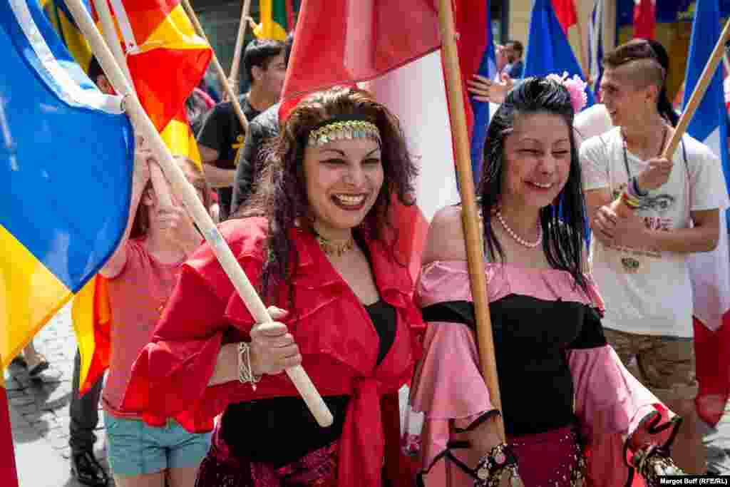 Women carry the flags of some of the countries whose musicians participated in the festival, including Romania, Russia, Spain, and Israel.