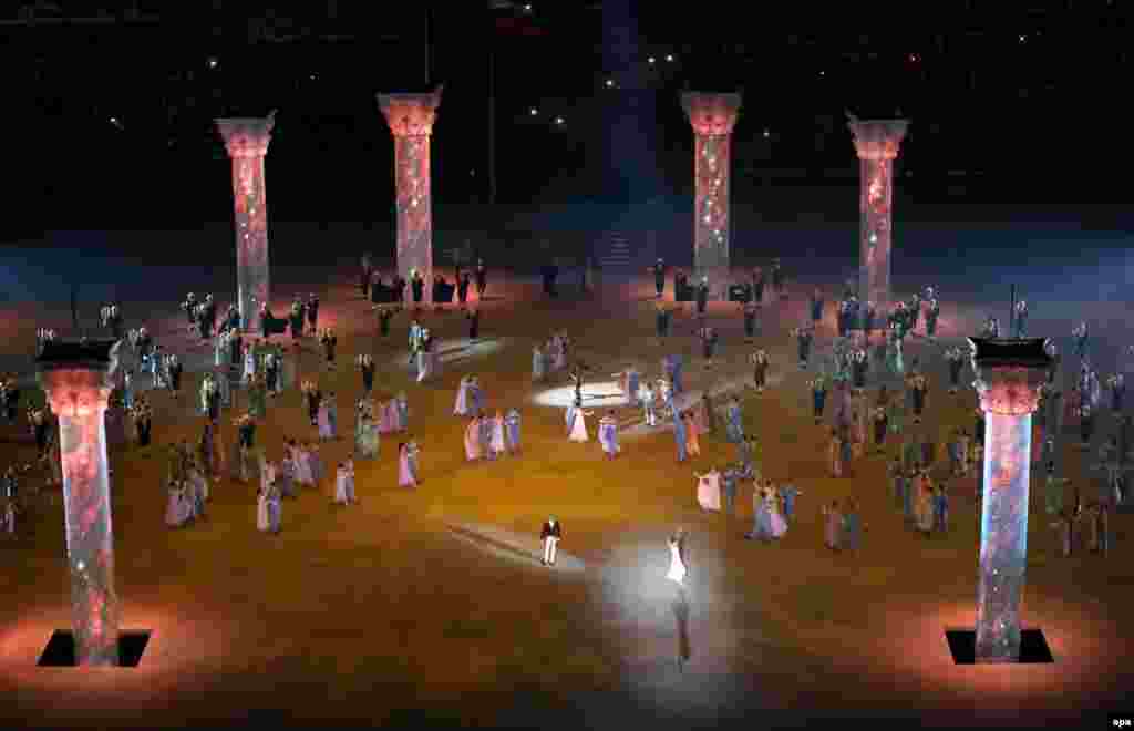 Giant columns columns rise from trap doors in the stadium floor