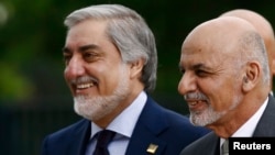 Afghan President Ashraf Ghani (right) with the country's Chief Executive Officer Abdullah Abdullah as they arrive for the NATO summit in Warsaw in July 2016.