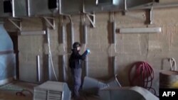 A TV grab shows an inspector from the Organization for the Prohibition of Chemical Weapons (OPCW) at work at an undisclosed location in Syria in October.