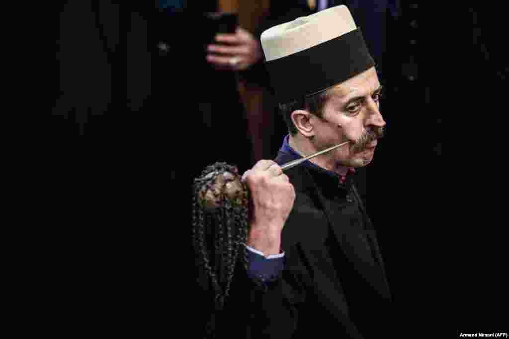 A Kosovar dervish pierces his cheek with a needle during a ceremony in Prizren during Persian New Year celebrations. The Kosovar dervish community carries on centuries-old mystical practices, such as self-piercing with needles and knives as a way to earn salvation and find the path to God. (AFP/Armend Nimani)