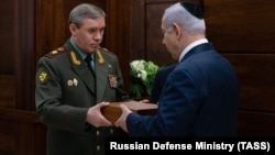 The chief of Russia's General Staff Valery Gerasimov and Israeli Prime Minister Benjamin Netanyahu attend a ceremony to hand over the remains of Israeli soldier Zachary Baumel, in Moscow on April 4. 
