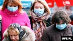 Kazakhs wearing protective masks against the flu in the city of Kostanai last month.