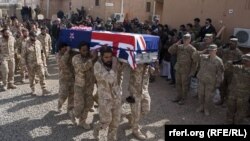 Soldiers carry the coffins of two New Zealand soldiers killed in Banyan Province in a battle with Taliban insurgents.
