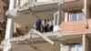 Iranians salvage a rug as they bring it down from a damaged building in the town of Sarpol-e Zahab in the western Kermanshah province near the border with Iraq, on November 14, 2017, following a 7.3-magnitude earthquake.