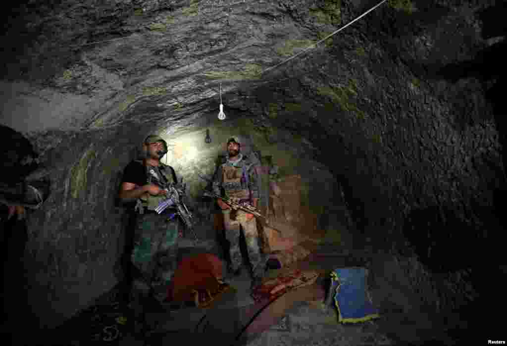 Afghan Special Forces inspect a cave that was used by suspected Islamic State militants at the site where the United States dropped its largest nonnuclear bomb earlier this month in the Achin district of the eastern province of Nangarhar. (Reuters/Parwiz)