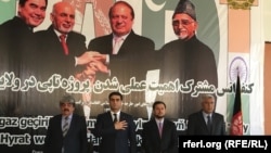 Officials from Turkmenistan, Afghanistan, Pakistan, and India meet at a TAPI project meeting in Herat, Afghanistan, in April, posing in front of a poster of the leaders of their countries.
