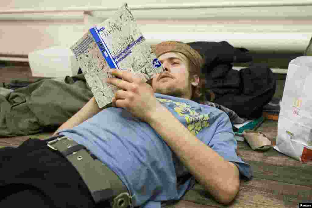 Political activist Pyotr Verzilov, the husband of Pussy Riot member Nadezhda Tolokonnikova, reads a book about anarchism by U.S. author Bob Black in Moscow in January 2009.