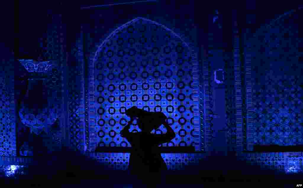 An Afghan walks through the courtyard of the Hazrat-e Ali shrine, or Blue Mosque, during the Islamic holy month of Ramadan in Mazar-e Sharif. (AFP/Farshad Usyan)