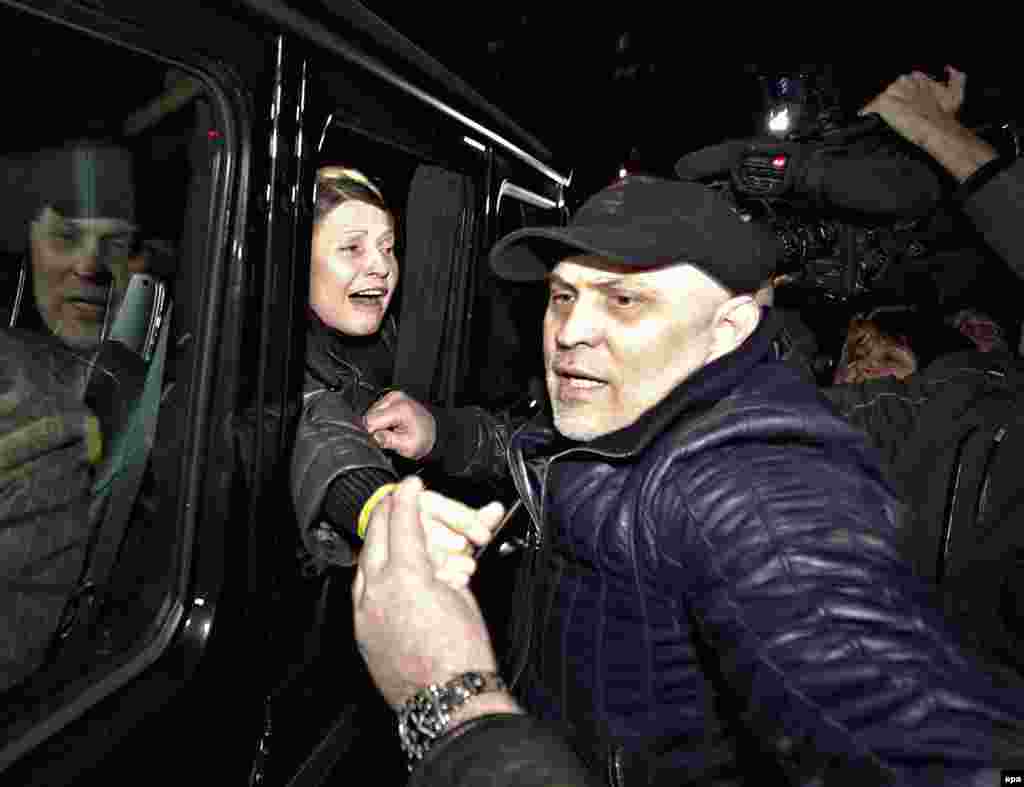 Tymoshenko greets supporters from a car as she leaves the Central Clinical Hospital in Kharkiv, Ukraine.