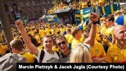 Polish fans Jacek (left) and Piotrek amid a sea of Swedish supporters during the Euro 2012 soccer championships in Kyiv on June 15.