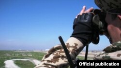 Afghanistan - An Armenian soldier guards a military airport near Kunduz.