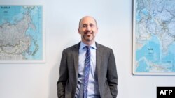 Rob Malley, former US negotiator during the Iran nuclear program negotiations and current CEO at the International Crisis Group, poses in his office May 7, 2018 in Washington, DC. President Donald Trump will confirm on May 8, 2018 whether he will make goo