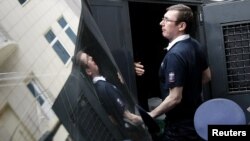 Ukraine's former Interior Minister Yuriy Lutsenko gets into a police truck after the court session in Kyiv on August 17.