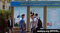 Молодые люди у информационного стенда Казахского аграрного университета в Алматы. Иллюстративное фото.