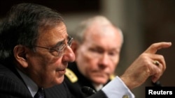 U.S. Secretary of Defense Leon Panetta (left) and U.S. Army General Martin Dempsey, the chairman of the Joint Chiefs of Staff, testify before the Senate Armed Services Committee on February 7.