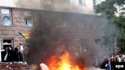 Moldova -- Protesters shout anti-communist slogans as a fire burns outside the parliament building in Chisinau, 07Apr2009