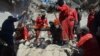 Iraqi firefighters look for bodies buried under the rubble of civilians who were killed after an air strike against Islamic State triggered a massive explosion in Mosul on March 27.