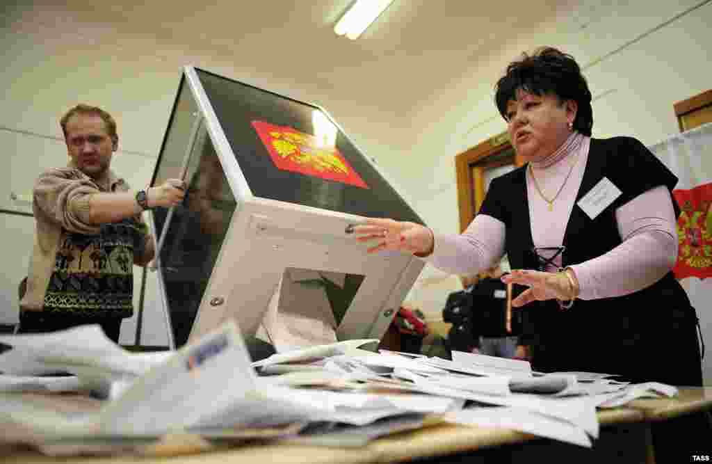 Members of the local electoral commission open ballot boxes at a polling station in Vladivostok.