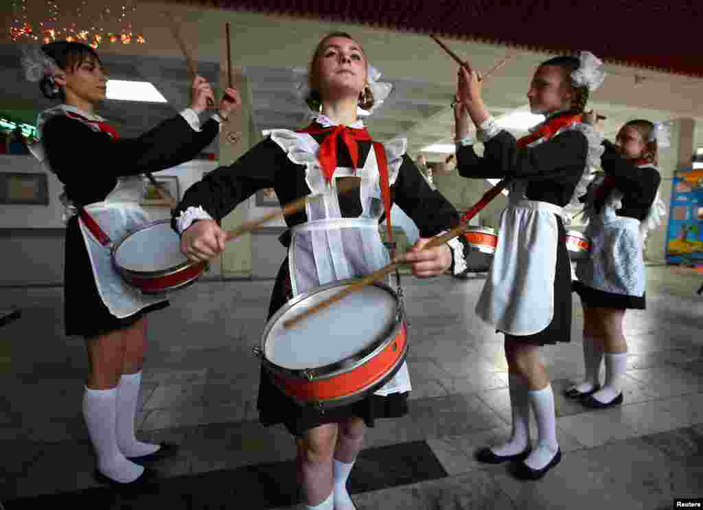 Belarusian schoolchildren, who are members of a pro-government Young Pioneer movement, perform with drums as they take part in a meeting to mark the 95th anniversary of their organisation in Minsk on May 19. (Reuters/Vasily Fedosenko)