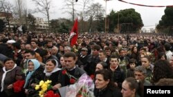 People attend a march to commemorate the three victims of last week's deadly riots in Tirana.