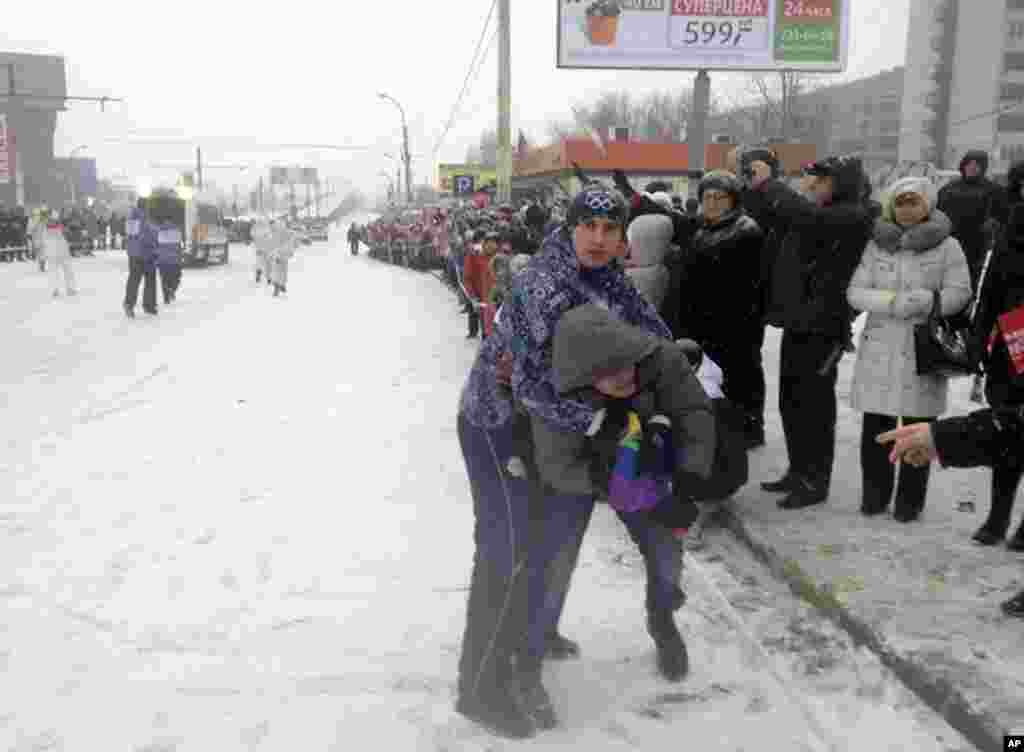 A gay-rights protester is detained by security personnel during the Olympic torch relay in the city of Voronezh, south of Moscow, on January 18. (AP/Andrei Nasonov)