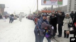 A gay rights protester is detained by security personnel during the Olympic torch relay in the city of Voronezh on January 18.