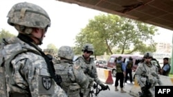 U.S. Army soldiers searching a vehicle in Baghdad on July 31