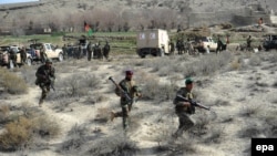 Afghanistan -- Members of the Afghan security services patrol following an operation against Islamic State militants (IS) in Achin district of Nangarhar province, Februaury 17, 2016