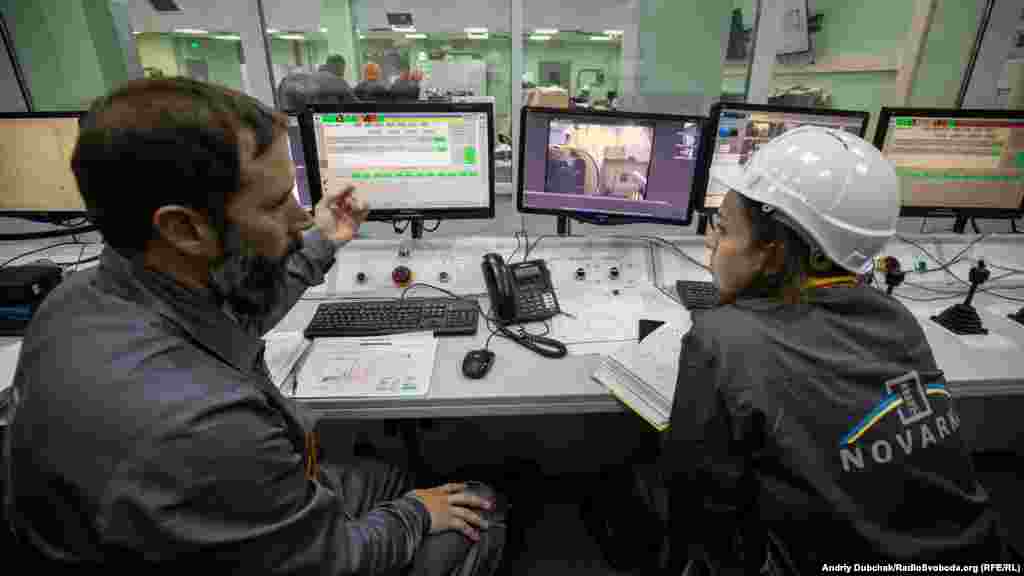 Two nuclear containment specialists inside the main control center at the New Safe Confinement (NSC). Some 3,000 people work at the site, including several foreign specialists.&nbsp;