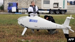 OSCE personnel prepare an unmanned drone near Mariupol in Ukraine in October 2014.