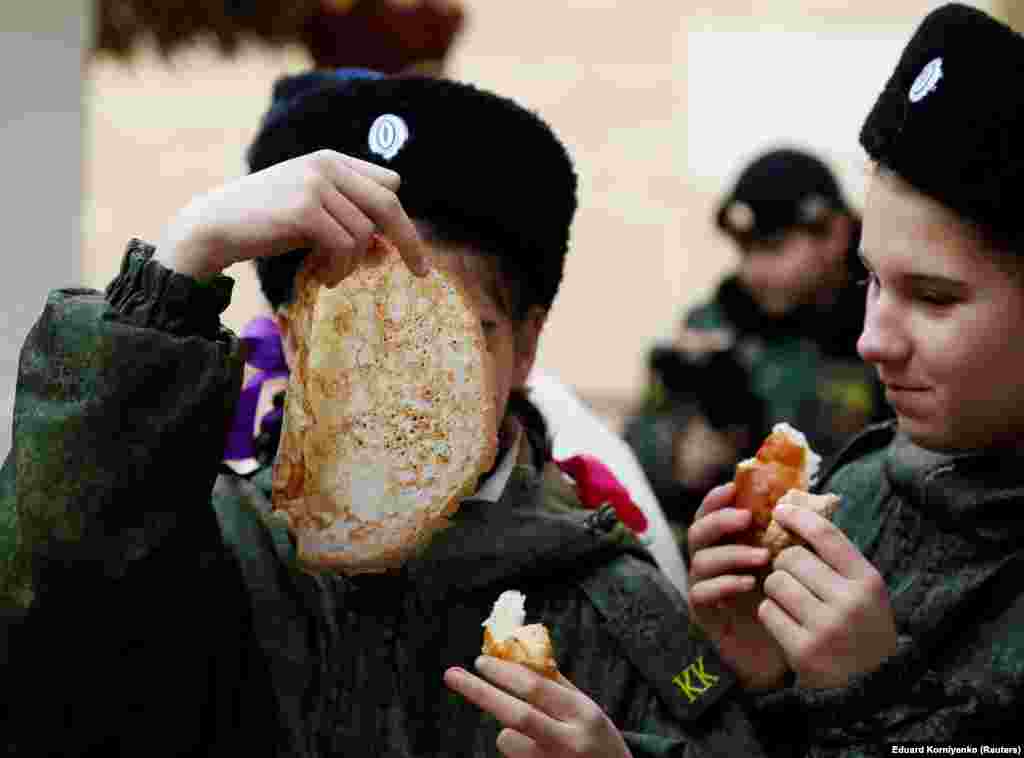 Students of the General Yermolov Cadet School eat pancakes in the southern city of Stavropol on February 29.