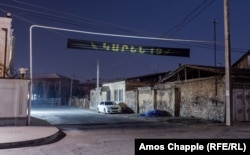 A black banner in Echmiadzin, a town near Yerevan, with the name Karen, and an age: 19