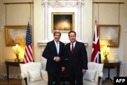 British Prime Minister David Cameron (right) meets with Kerry at 10 Downing Street.