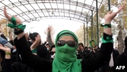 An opposition supporter gestures as she takes part in an anti-government demonstration on December 7 at Tehran University