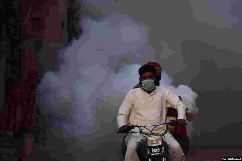 Public-health workers fumigate the streets in Hyderabad, India. (​Reuters/Yasir Ali)