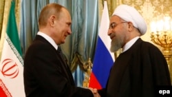 Russian President Vladimir Putin (left) meets with Iranian President Hassan Rohani at the Kremlin in Moscow on March 28.