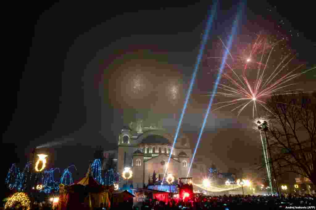 People watch as fireworks explode over the Saint Sava Church to mark the Orthodox Christian New Year in Belgrade, Serbia, on January 14. (AFP/Andrej Isakovic)