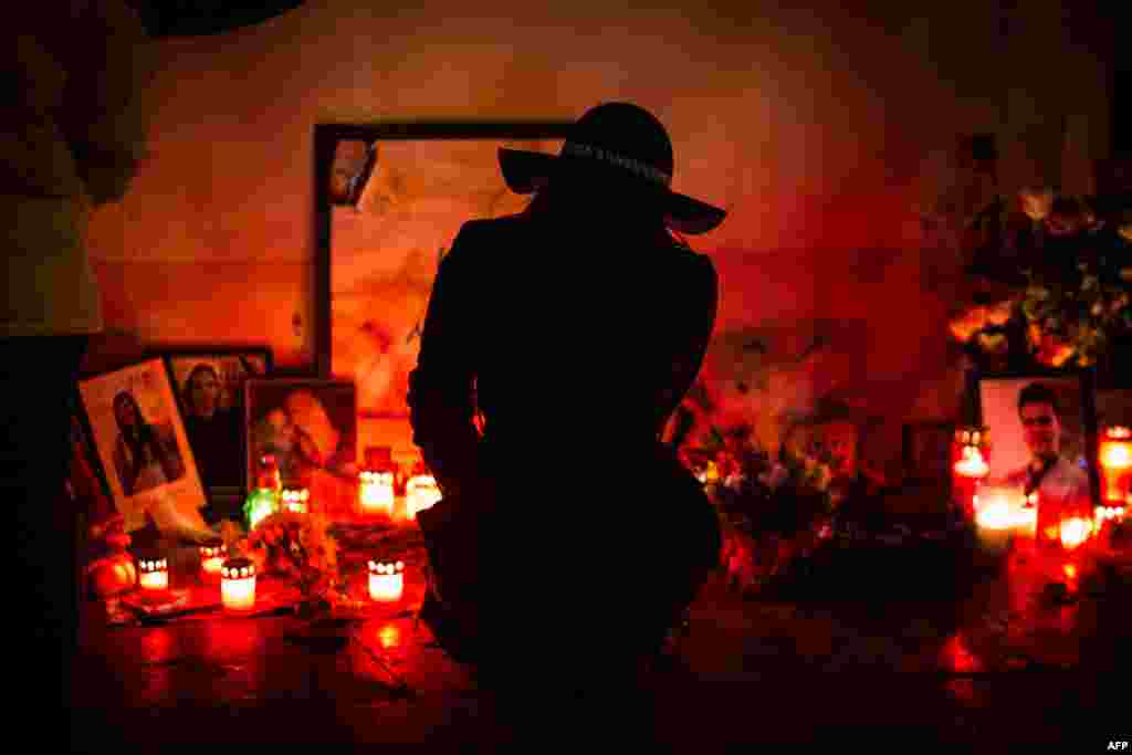 A woman mourns during a commemoration for the victims of fire in a Bucharest nightclub where 63 people were killed and over a hundred injured on December 30 last year. (AFP/Andrei Pingovschi)