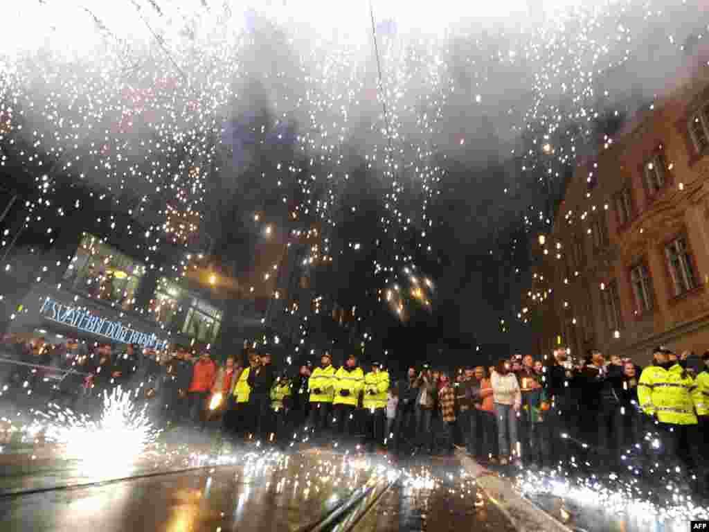 Czechs watch a fireworks display symbolizing the fall of the Iron Curtain in Prague on November 17, the anniversary of the 1989 protests that sparked the peaceful Velvet Revolution. 