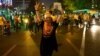 Hassan Rohani flashes a victory sign as he leaves a polling station after voting in Tehran on June 14.