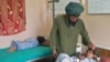 Abdul Ghaffar comforts his wounded child at a hospital in Kandahar on July 24.