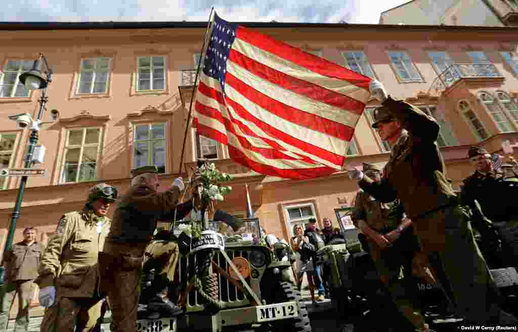 Members of a historical military club in World War II uniform hoist a U.S. national flag during the traditional Convoy of Liberty to commemorate the 74th anniversary of the liberation of the western part of the country from Nazi rule by the U.S. Army, in Prague on April 26. (Reuters/David W Cerny)
