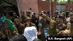 Police officers hold back supporters of Pakistan's jailed ex-Prime Minister Nawaz Sharif as they gather outside the Adiala jail where he is being held in the northwestern city of Rawalpindi.
