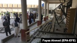 Pakistani security officials inspect the scene of a bomb blast on August 16. 