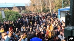 Dec. 30, 2017 file photo obtained by Associated Press outside Iran. University students attend a protest inside Tehran University while anti-riot Iranian police prevent them to join other protesters.